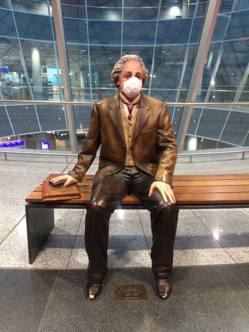 HEALTH MESSAGE: A statue of Albert Einstein at Frankfurt Airport wears a face mask. 