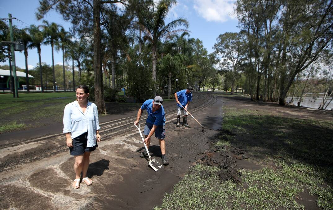 Jaclyn Guerin, Pete Graham and Tod Sutherland clean up the BIG4 Nelligen Holiday Park after the flood. Photo: Adam McLean