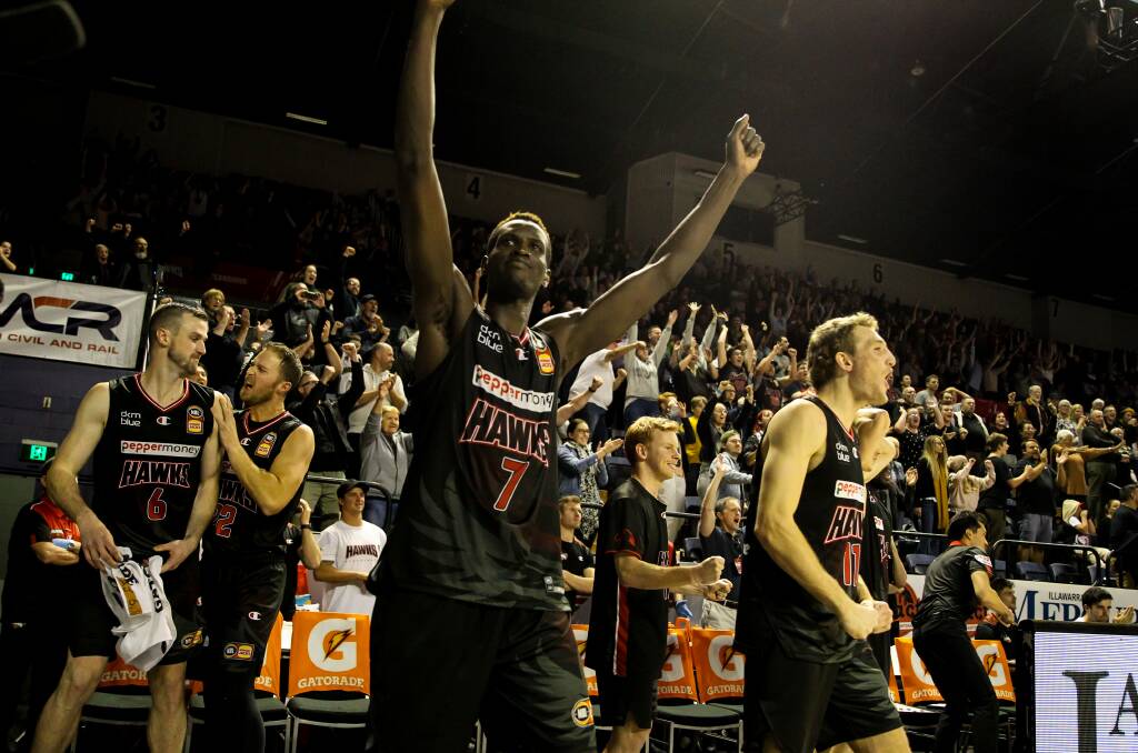 Deng Deng - and Illawarra fans and players - celebrate after the Hawks beat Perth at the WEC last week. Photo: Adam McLean
