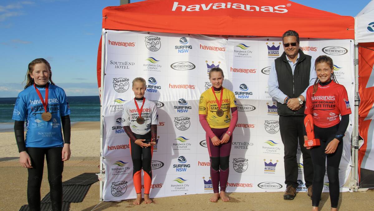 Under 12 girls winner, Gerringong's Lucy Darragh (right), with the other place-getters in her category. Photo: Ethan Smith/Surfing NSW