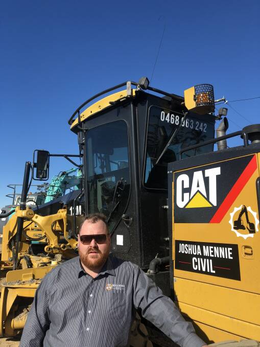THE RIGHT EQUIPMENT: Director Joshua Mennie with his most recent purchase - a 12M cat grader.    