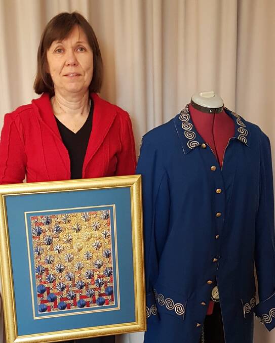 INTRICATE: Linda Taglieri with two of her works, a 17th century style man's coat and a canvaswork The Midas Touch.