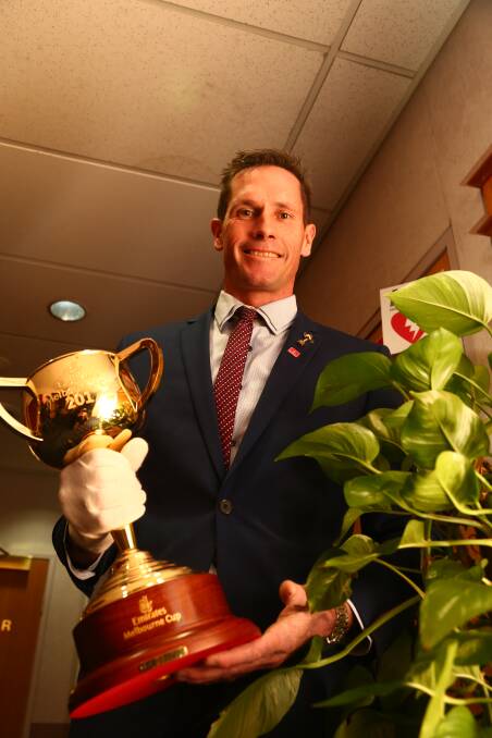 BLOOMING TRICKY: Flemington racecourse gardener Mark Budge works throughout the year to ensure the course is adorned with perfect roses for cup day.