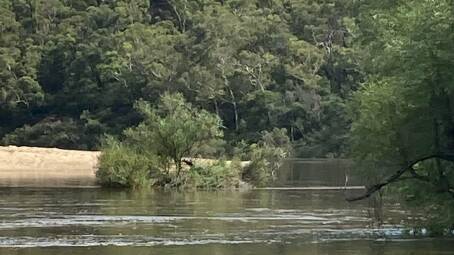LUCKY ESCAPE: Kayakers rescued a family from the roof of their car at Stewarts Crossing, east of Tarago on Sunday morning after they drive into floodwaters. Photo: Braidwood SES.