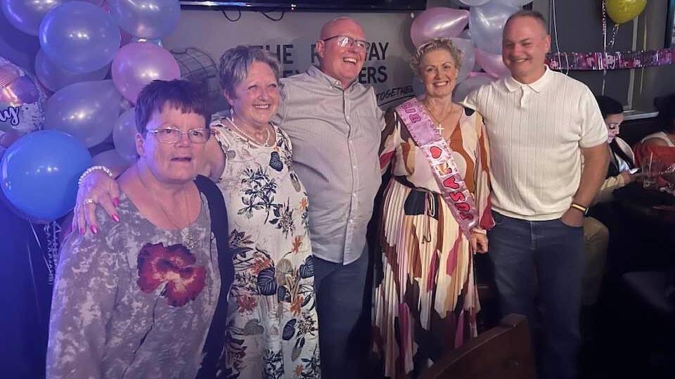 Susan Gervaise, conmplete with sash, and family celebrate her 57th birthday in the local pub. Picture supplied
