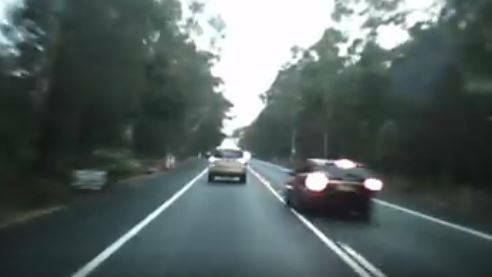  The driver of the black car veers onto the wrong side of the road to overtake Steve Knox, narrowly missing a head-on collision with a northbound vehicle.