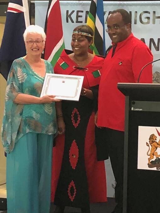 RECOGNITION: Rhonda Moore accepting her award from the High Commissioner of Kenya Ambassador Isaiya Kabira and his wife Betty. 