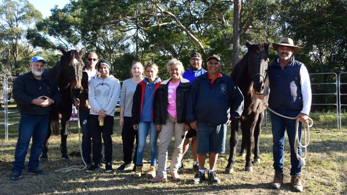 Scott Brodie (right) teaching the group the basics of horse retraining at Nowra Local Aboriginal Land Council on Wednesday. 