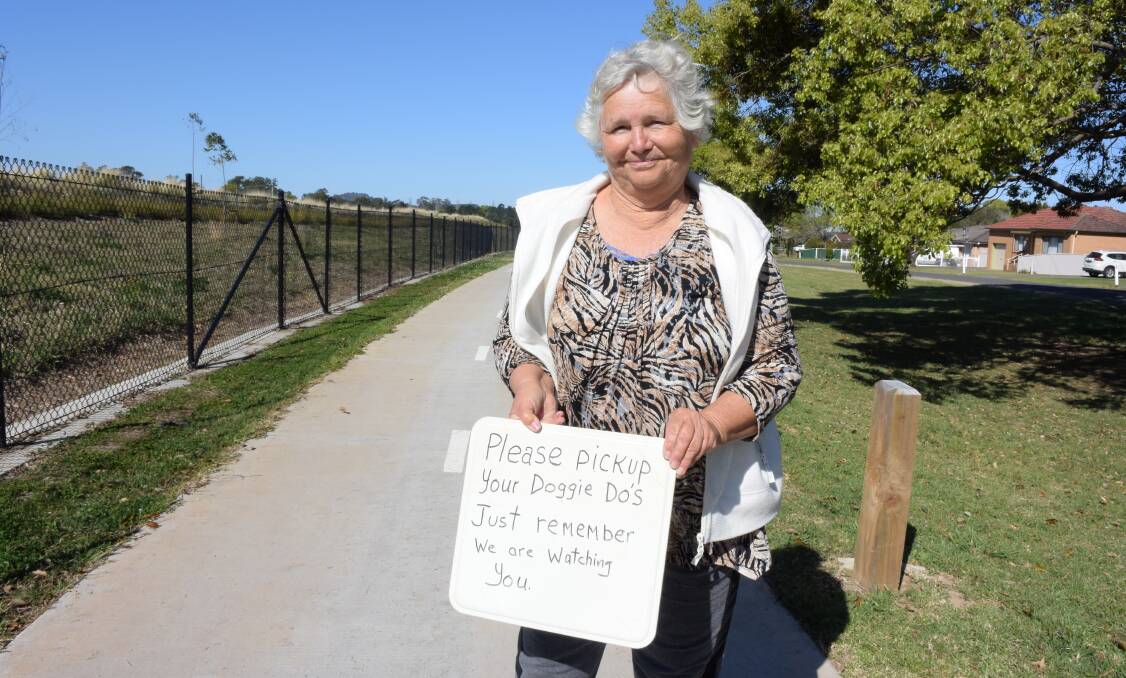 DO THE RIGHT THING: Berry resident Yolande Buchan has put signs along the North Street Shared Path instructing walkers to pick up their dog poo. 