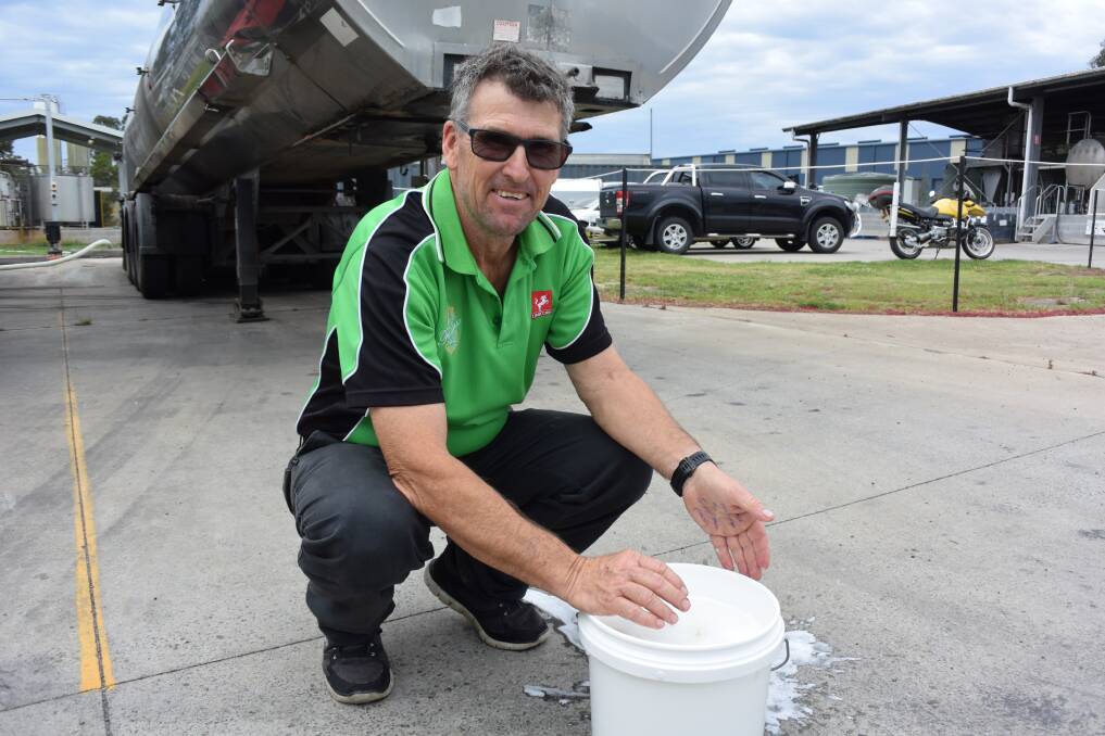 Unicorn Cheese production manager Graeme Banister with a bucket of whey. 