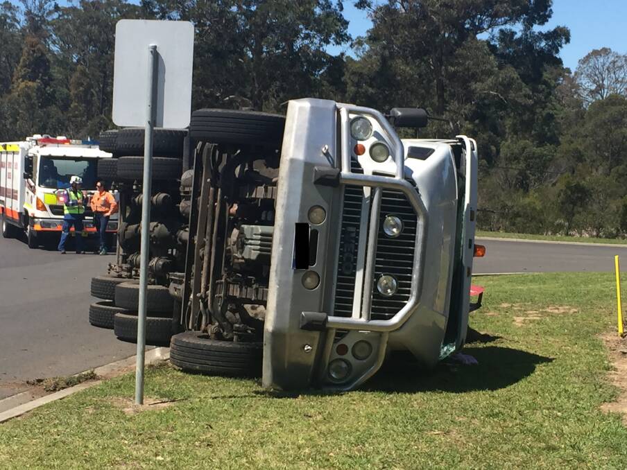 The truck rolled just before 1.30pm at Cumberland Avenue, South Nowra. Photo: Robert Crawford. 
