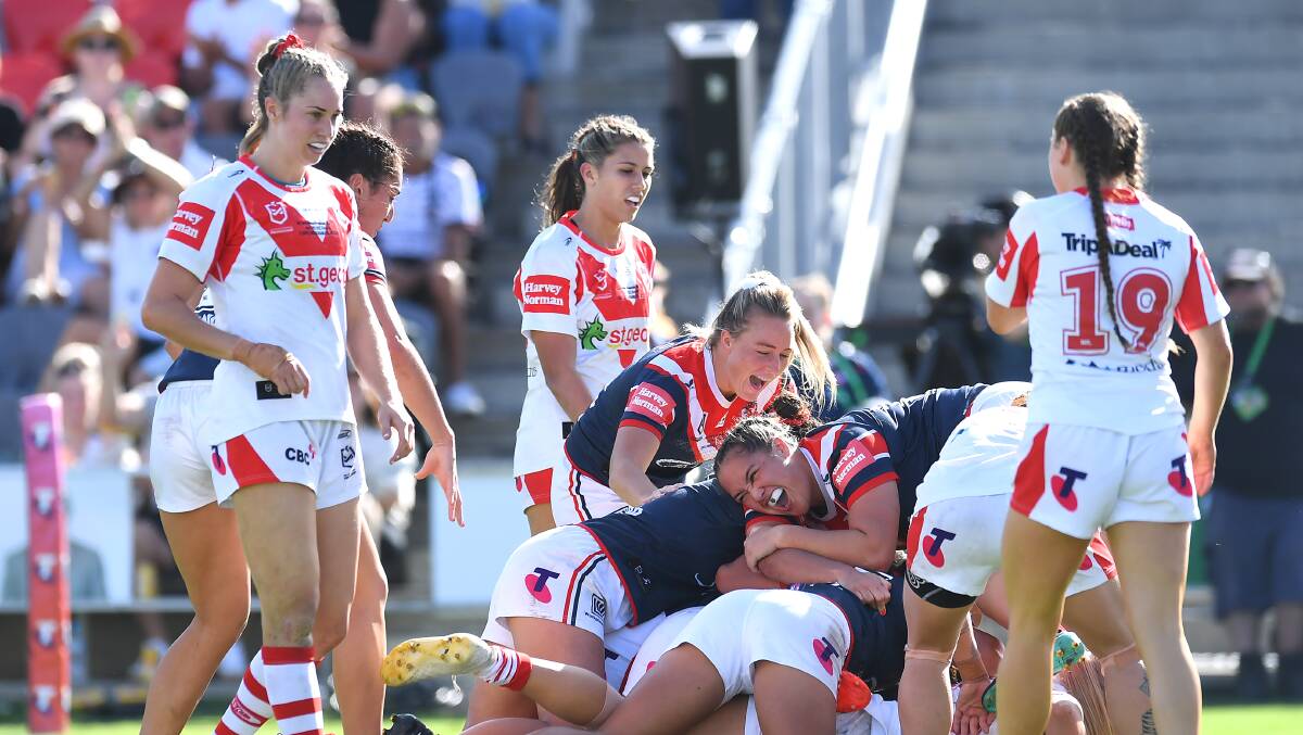 Heartbreaker: The St George Illawarra Dragons look on with disappointment as Roosters celebrate Isabelle Kelly's match-winning try in Sunday's NRLW grand final. Picture: Albert Perez/Getty Images