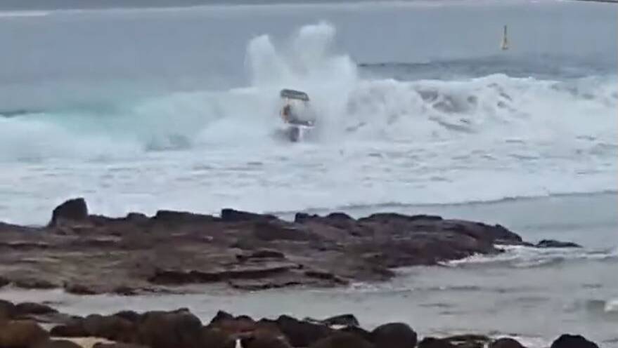 Boaters come to grief on a large swell at the Merimbula bar on Sunday. 