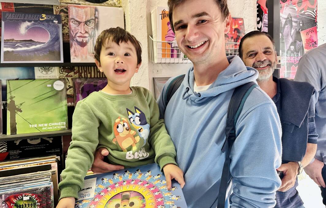 Two-year-old Jeremy Day was among the first of the kids to get his hands on the special picture disc edition of a new Bluey album, Dance Mode, with his parents Anna and Damien making a special trip to secure the purchase.