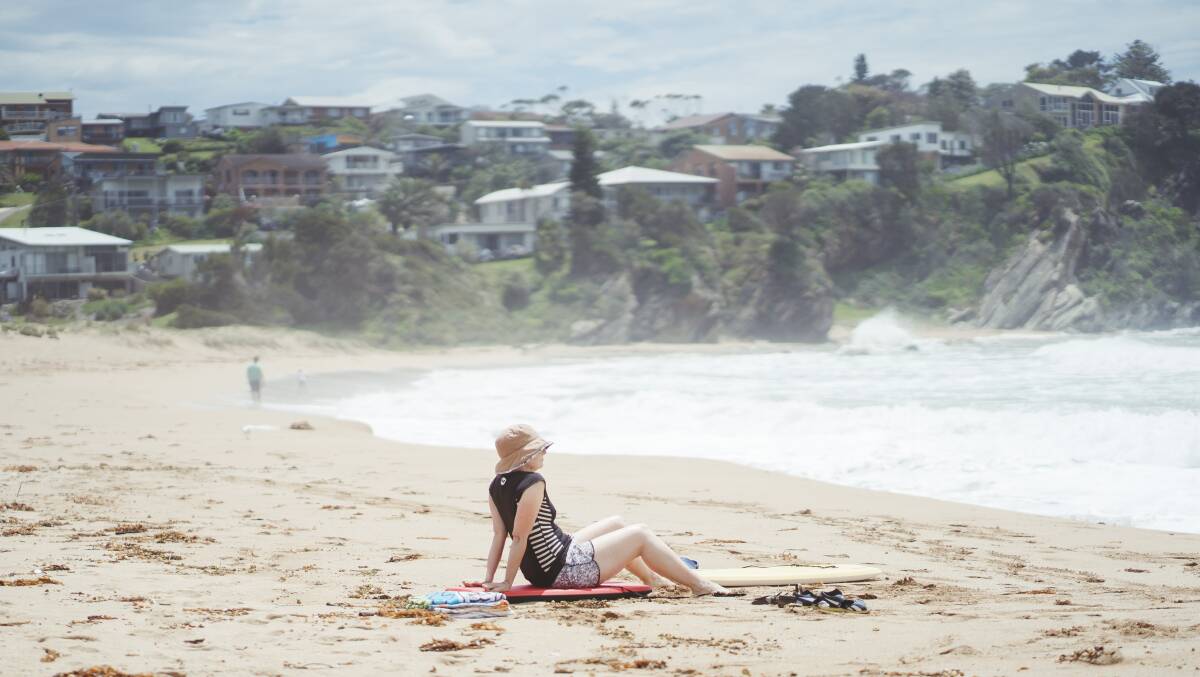 A woman enjoying Malua Bay beach. Question marks remain over South Coast holiday plans. Picture: Dion Georgopoulos