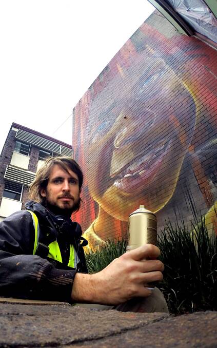 Talent: Matt Adnate's mural on Nowra Library's back wall took three days, 20 litres of paint and 70 spray cans to finish. Photo: Jessica Long