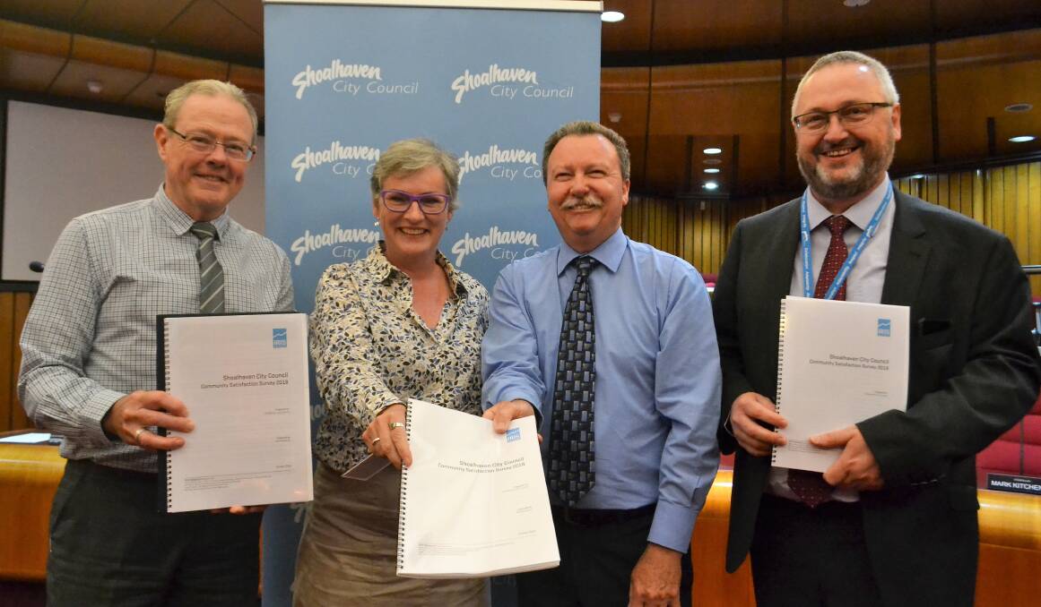 HAPPY TO BE HERE: Shoalhaven Council's Phillip Costello, Amanda Findley, Russ Pigg and Stephen Dunshea hold survey results. Picture: Rebecca Fist
