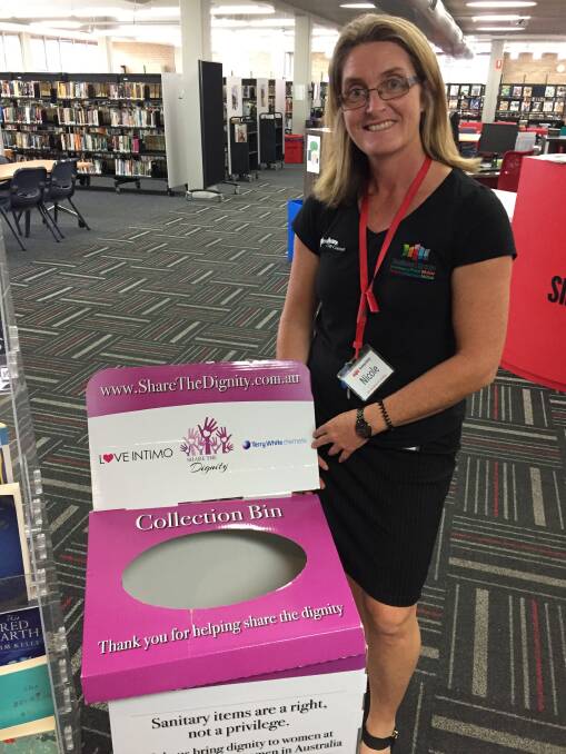 ON BOARD: Nicole Lonesborough from Shoalhaven Library, one of many local organisations supporting the appeal, housing a collection bin on site. Picture: Rebecca Fist