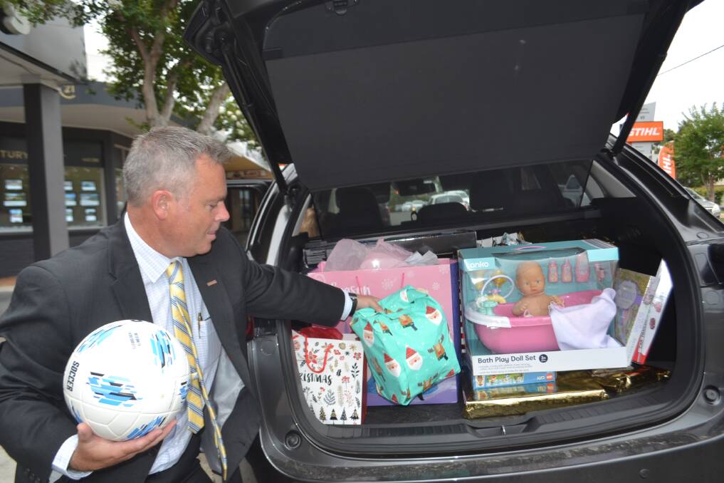 Jaime Gossage from Ray White with a boot full of presents in Nowra on Friday. Picture: Rebecca Fist