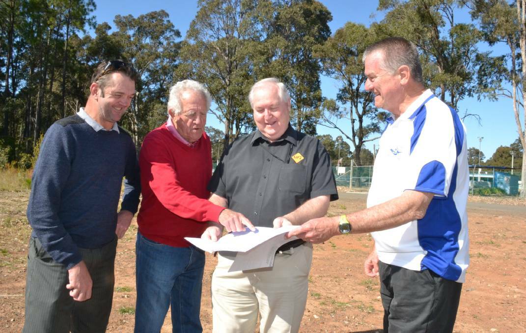 Andrew and David Goodman (left) from Crescent Home Plan and Design Service who have designed the South Coast Surf Life Saving facility at West Nowra, president Steve Jones and director of education Jim Connolly look over the centre plans in 2017.