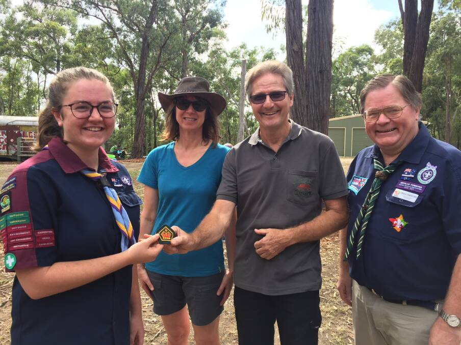 Julia Nowak receives her badge with parents Clare Nowak and John Mason, and Scouts Chief Commissioner Neville Tomkins at Bangalee on Saturday. Picture: Rebecca Fist