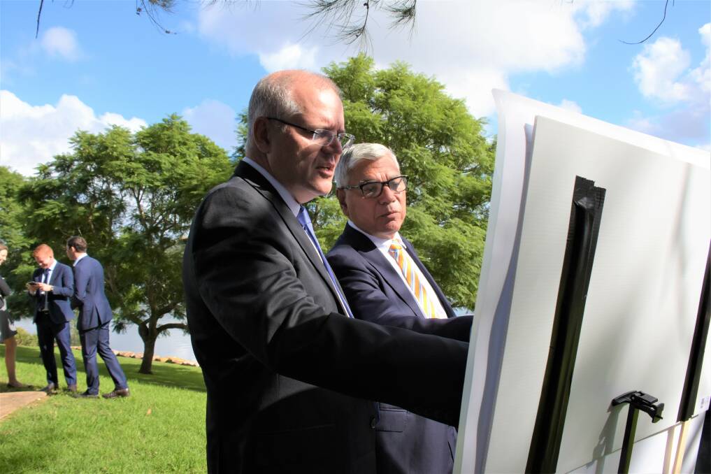 ON THE MAP: Prime Minister Scott Morrison and Liberal Gilmore Candidate Warren Mundine on the banks of the Shoalhaven River, observing a map of the Princes Highway on Friday. Picture: Rebecca Fist