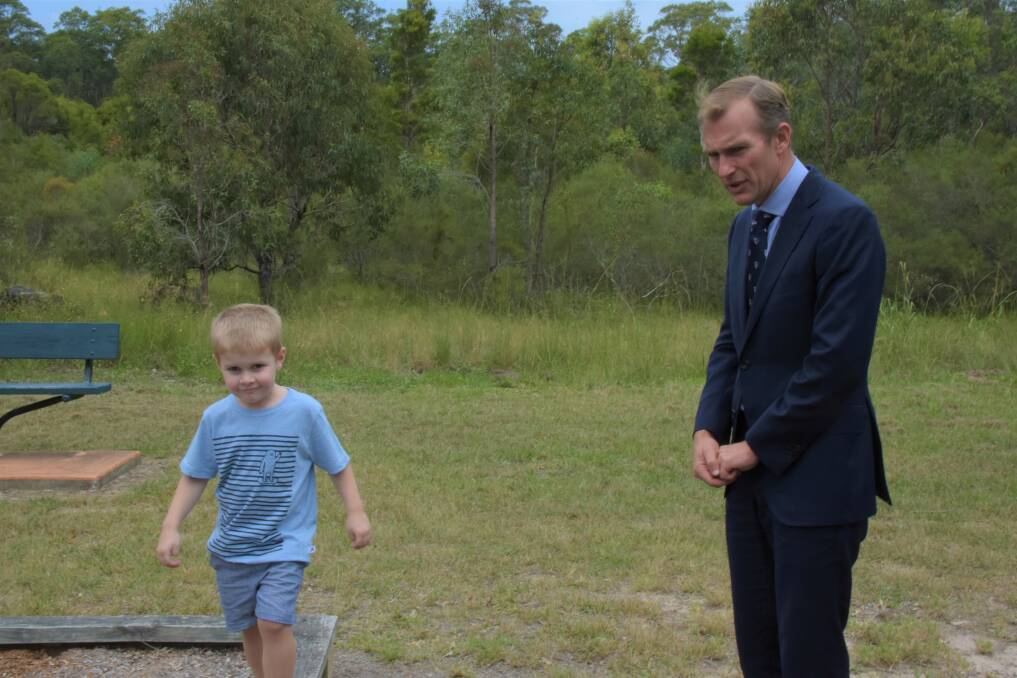 Van, 3, and NSW Education Minister Rob Stokes at a playground in Worrigee on Wednesday. Picture: Rebecca Fist