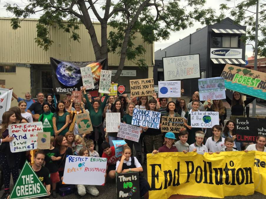 Students march from the Nowra Showground to Jelly Bean Park on Friday to protest government inaction on climate change.