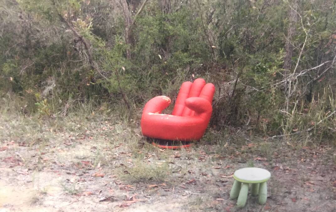 Arguably the world's ugliest chair has been dumped on a fire trail off Yalwal Road. Picture: Ron Witz