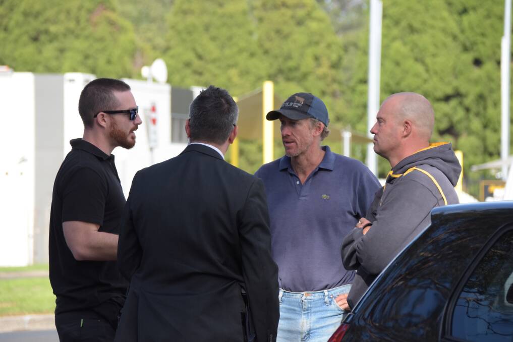 NOT SO FAST: The Prime Minister's security detail keeps a close watch on Shoalhaven dairy farmers Tim and Daniel Cochrane on Friday.