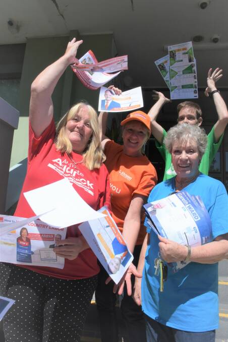 HOW TO VOTE: Volunteers hand out voting recommendations at the Nowra pre-poll booth including the CDP's Michelle Green, Greens' Brad Gully, Labor's Liz Folkard and Liberal's Elza Maynard. Picture: Rebecca Fist