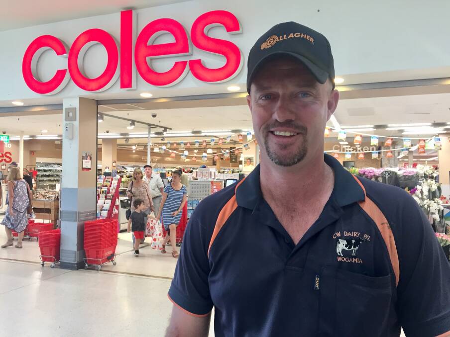 Daniel Cochrane visits Coles Nowra on Wednesday, to see the milk price changes for himself. Picture: Rebecca Fist