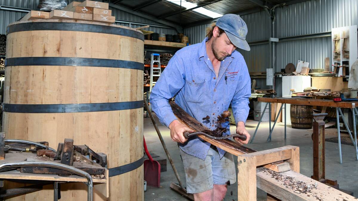 Laurie planes down some of the staves for the barrel he's working on. 