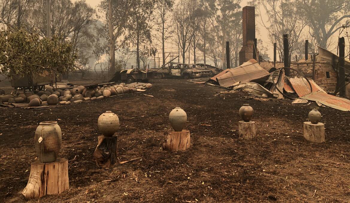 Incredibly, these pots survived the bushfire that destroyed the Bandicoot Pottery studio by sitting where they are in this picture, on the tree stumps. 