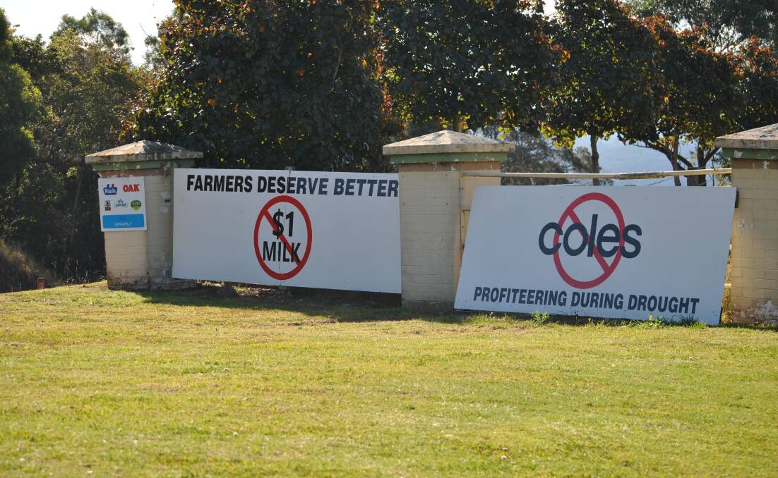 The signs erected on the Princes Highway at Miltn show a message from dairy farmers desperate for a price rise to stay in business during the drought. 