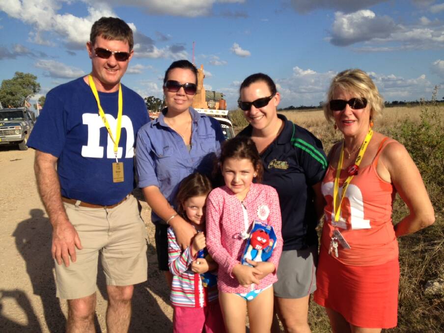 Chairman of Variety South Coast Brian Muller with fellow team member Di Wilbraham and outback residents during one of their many Variety Bash events. 