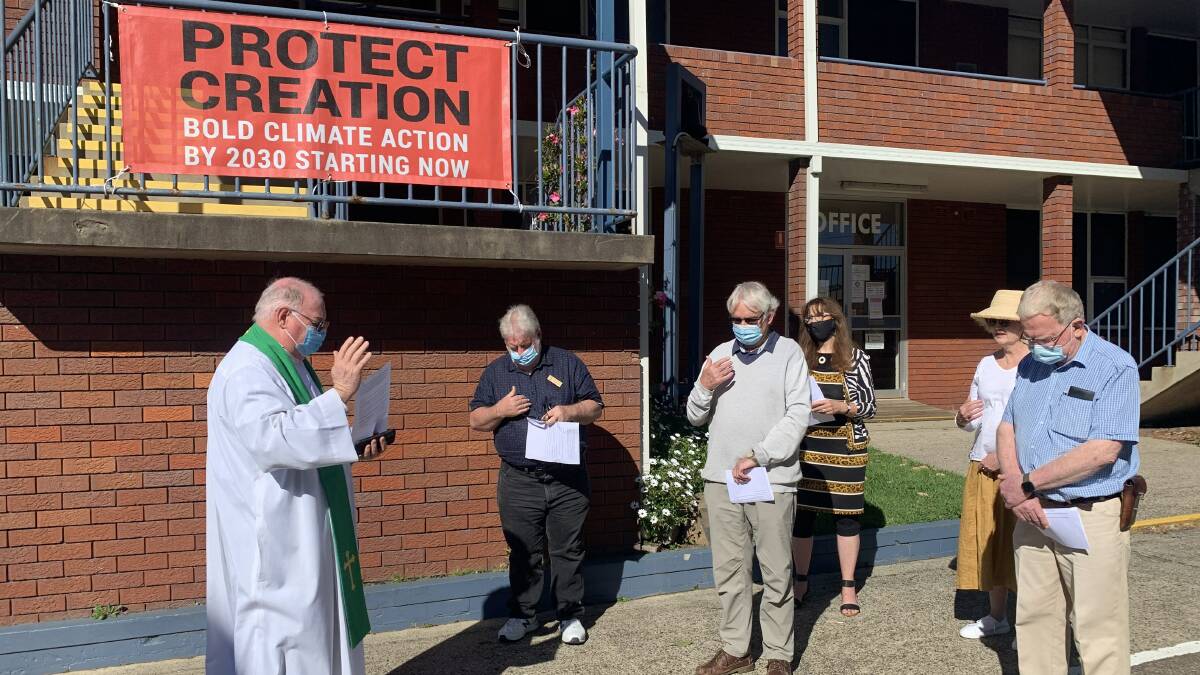 CONCERNS: St Peter and Paul Catholic Church Father Chris Roberts leads the prayer on Faiths4Climate Global Day of Action on Sunday.
