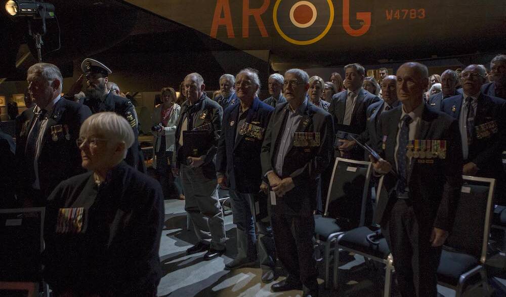 Members of Helicopter Flight Vietnam and their guests stand for the National Anthem during the Unit Citation for Gallantry presentation at the Australian War Memorial, Canberra. Photo: James McDougall 