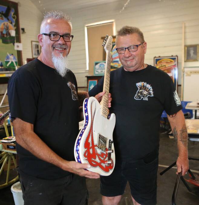 US pinstriper Todd Hanson and Culburra Baech's Paul Metcalfe and the specially designed hand painted guitar.