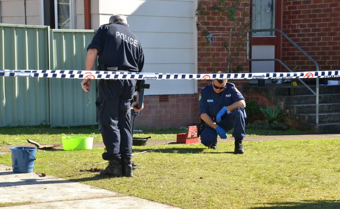 FLASHBACK: Crime scene officers used metal detectors to search the front lawn of a home in North Nowra in 2017 after a man was allegedly stabbed.