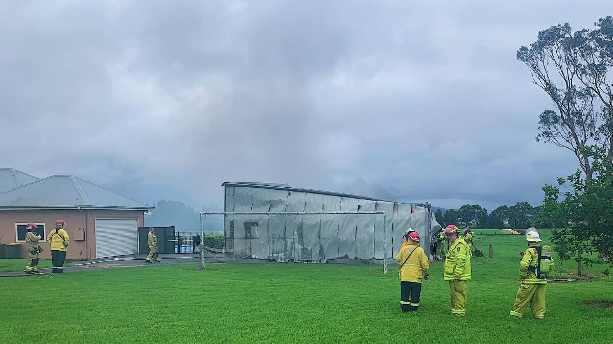 Emergency services rushed to a shed fire at Worrigee, east of Nowra, around 5pm on Sunday. Two 17-year-old boys suffered burns in the incident when a boat's fuel tank erupted in flames. Image: Shoalhaven Heads RFS