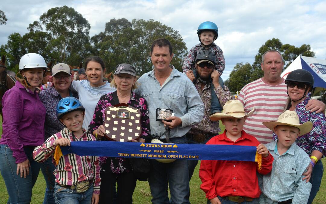 WELL DONE: Maureen Bennett presents Michael Green, the inaugural winner of the Terry Bennett Memorial Open Flag Race at this years Nowra Show with the buckle and memorial trophy. Helping Maureen are family members Emily Robinson, Naomi Bennett, finalist Ally Mathie, Scott Robinson with grandson Logan, Grant and Ellen Mellon. Front row: Grandchildren Wyatt Robinson, Harrison and Edward Mellon.