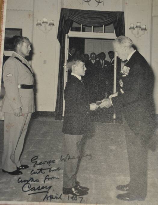 Young George Wheatley accepts his father’s Victoria Cross from Lord Casey in 1967.
