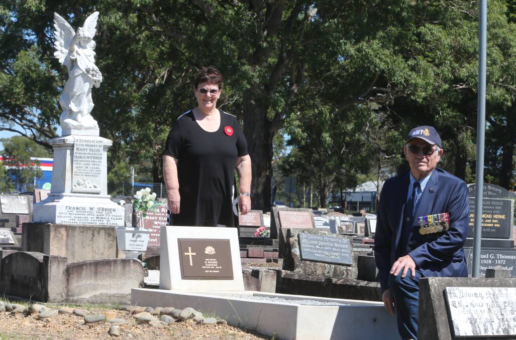 GREAT TEAM: Local historian Robyn Florance and Graham Morrison have combined to find 13 WWI diggers' unmarked graves in the Nowra General Cemetery. They are pictured with Private Robert Kearns' gravesite which was rededicated on Remembrance Day.
