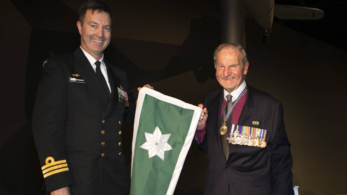  
RECOGNITION: Rear Admiral Neil Ralph (right), presents the Unit Citation to 723 Squadron CO, Commander Bruce Willington. Photo: James McDougall 