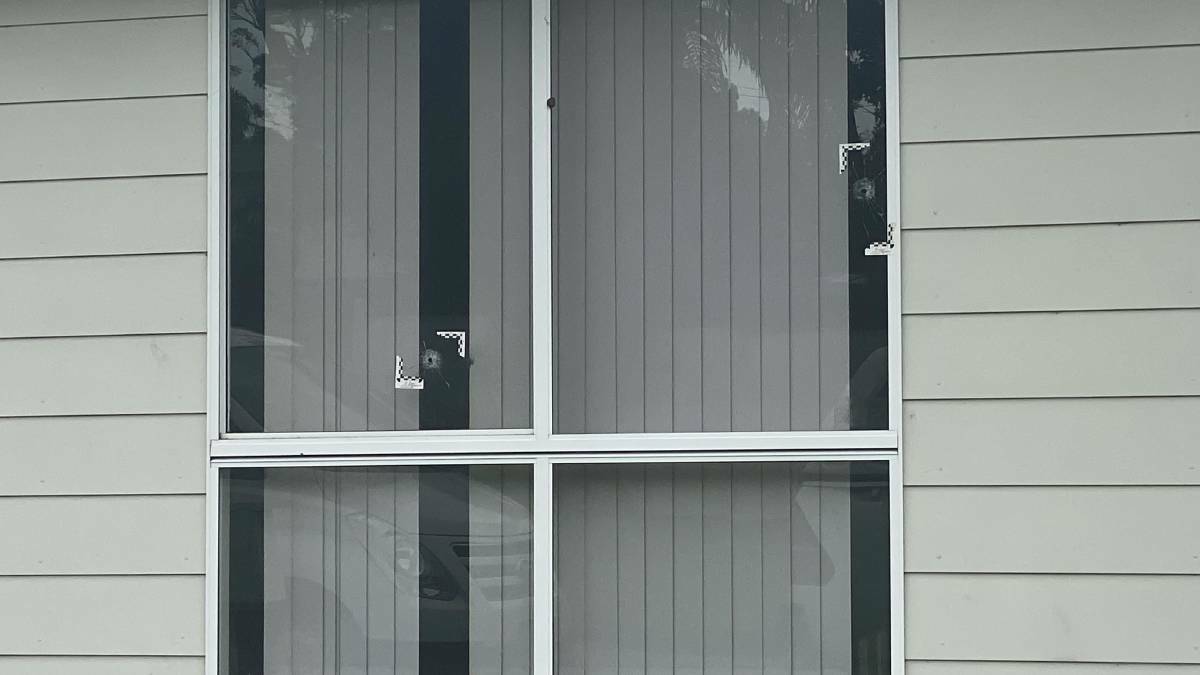 DAMAGE: Two large gun shots punctured the front window of a Bunderra Drive home this morning. Image: Grace Crivellaro.