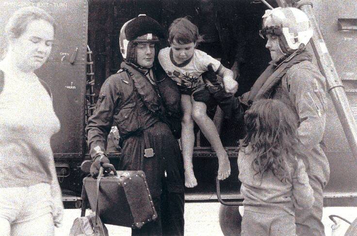 HT725 Squadron personnel assist evacuees out of a Wessex helicopter during the Nowra floods in 1974. Photo: Defence