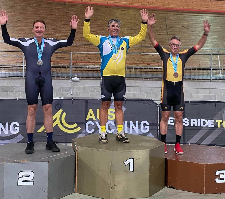 SUCCESS: Adrian McMillan (centre) tops the podium for a gold medal at the NSW Masters Championships. Image: Supplied
