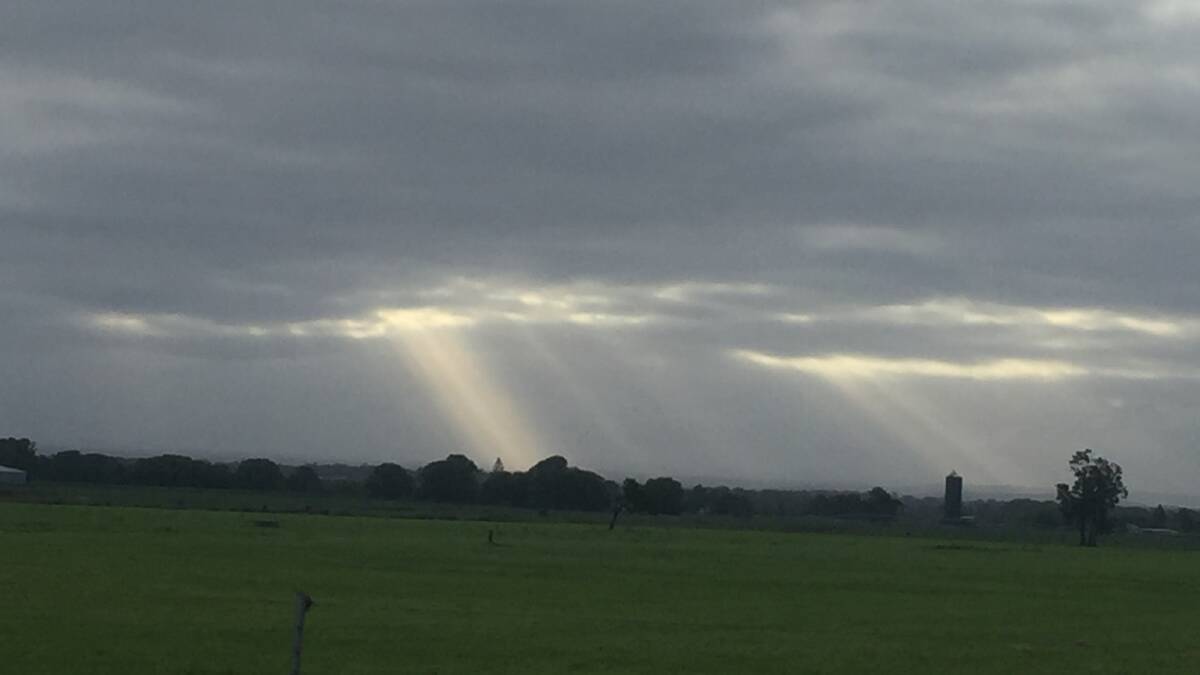 PIC OF THE DAY: Light breaks through storm clouds over the floodplain east of Nowra. Photo: Robert Crawford. Email your photos to editor@southcoastregister.com.au