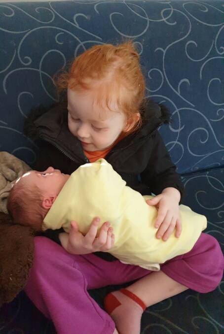SISTERLY HUGS: Frankie's older sister Evie holding her for the first time. 
